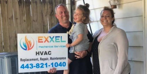 Family holding one of our signs after recent HVAC mount airy service