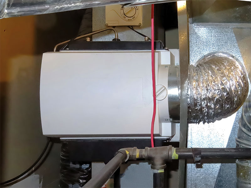 Whole-home humidifier attached to HVAC system ductwork.